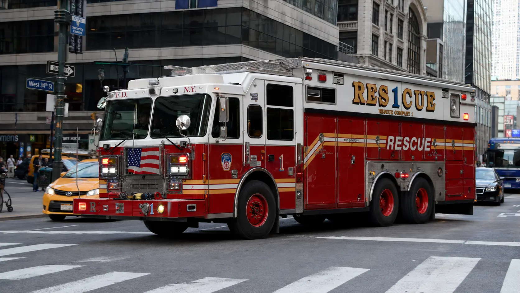 Photorealistic photo of an FDNY Rescue Company heavy rescue truck &mdash; a large red box-body apparatus with RESCUE 1 lettering &mdash; responding through Manhattan traffic with lights and siren active, the distinctive large rescue body carrying specialized equipment visible through the compartment doors, NYC buildings and traffic visible, 16:9 ratio