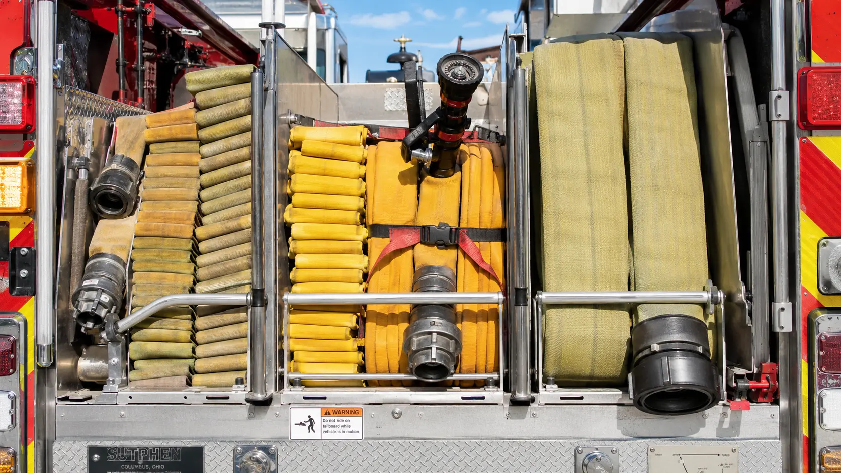 Preconnected attack hose and supply hose packed in the rear bed of a fire engine.