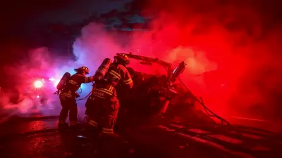 Firefighters rescue a cat from a smoke-filled house during a blaze in Dalton early morning.