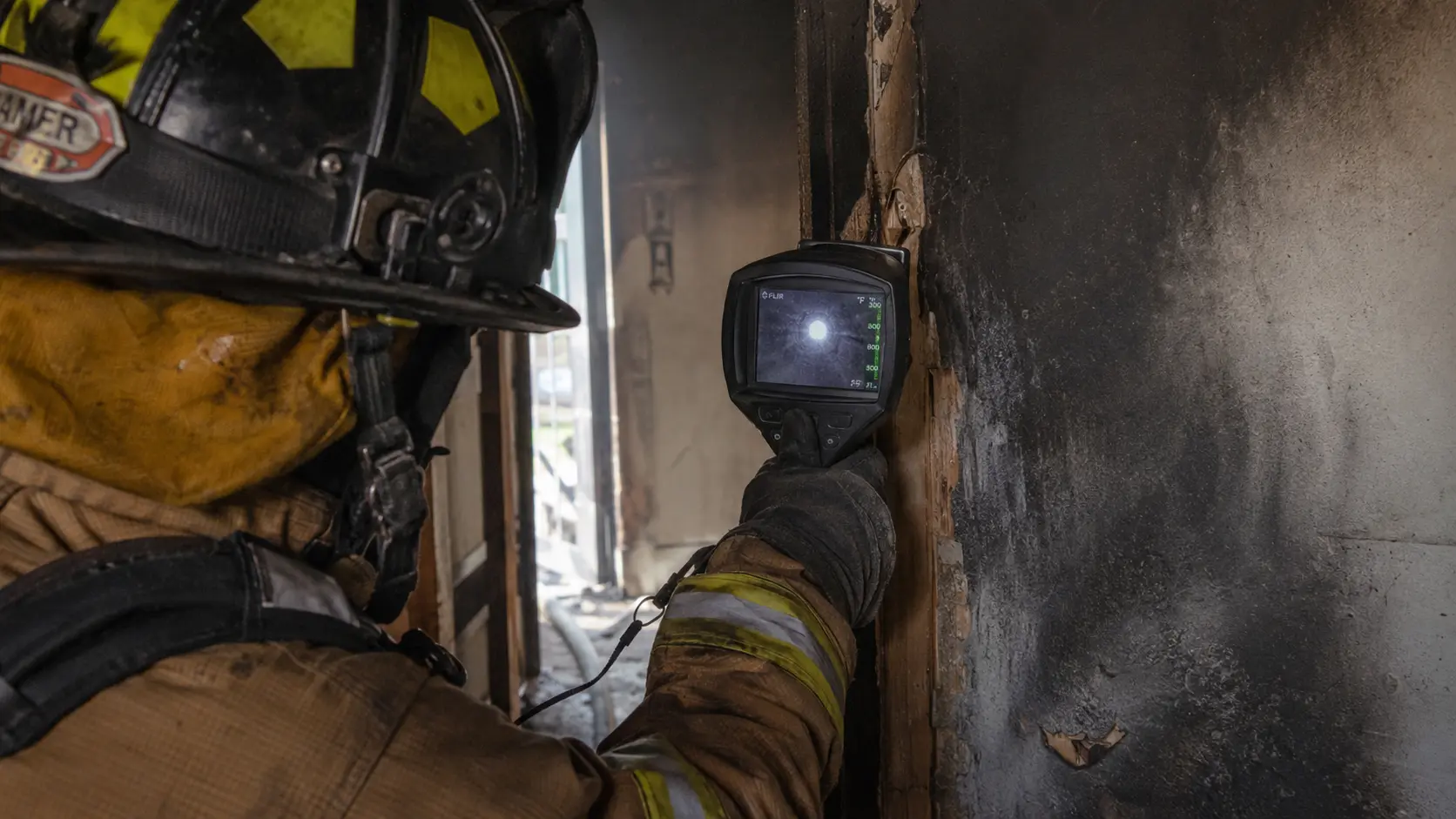 Thermal imaging camera display highlighting a hot spot inside a wall during overhaul.