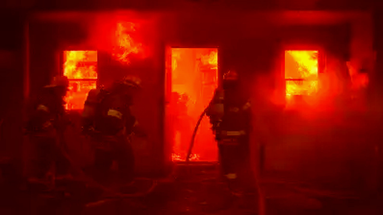 Firefighters battling a fierce blaze in a residential area of Owensboro, smoke billowing into the sky.