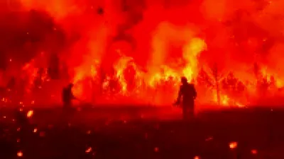 Firefighters battling flames in a historic California gold rush town devastated by wildfire.