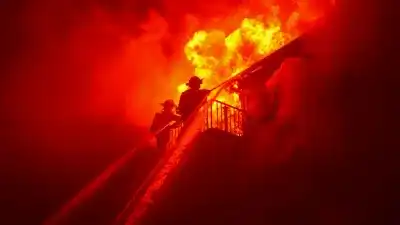 Firefighters battle intense flames and thick smoke at a residential house fire in Hyde Park.